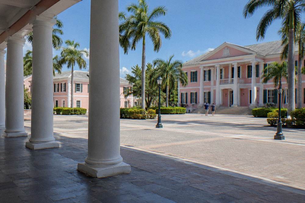Pastel government buildings and a palm-lined square in downtown Nassau