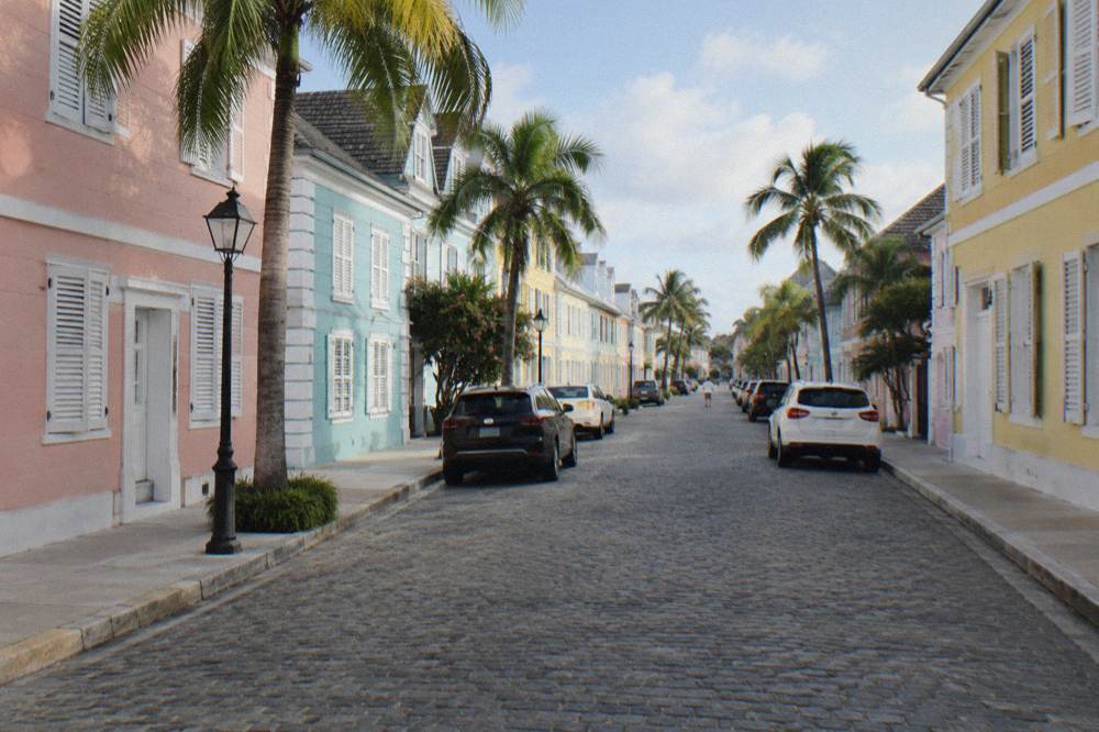 Cobblestone Nassau street with pastel colonial buildings in morning light