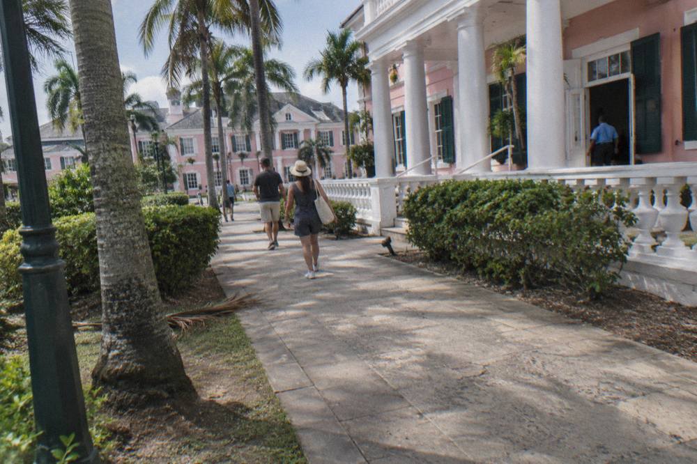 Pastel government buildings at Parliament Square in Nassau with palm trees