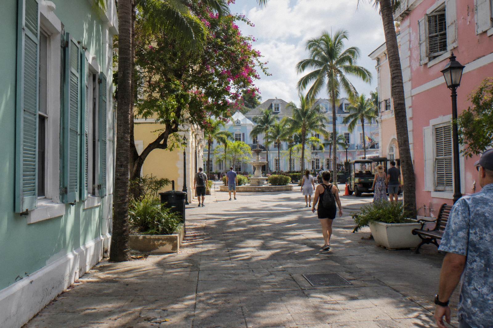 Pastel colonial buildings along a quiet Nassau street under a blue sky