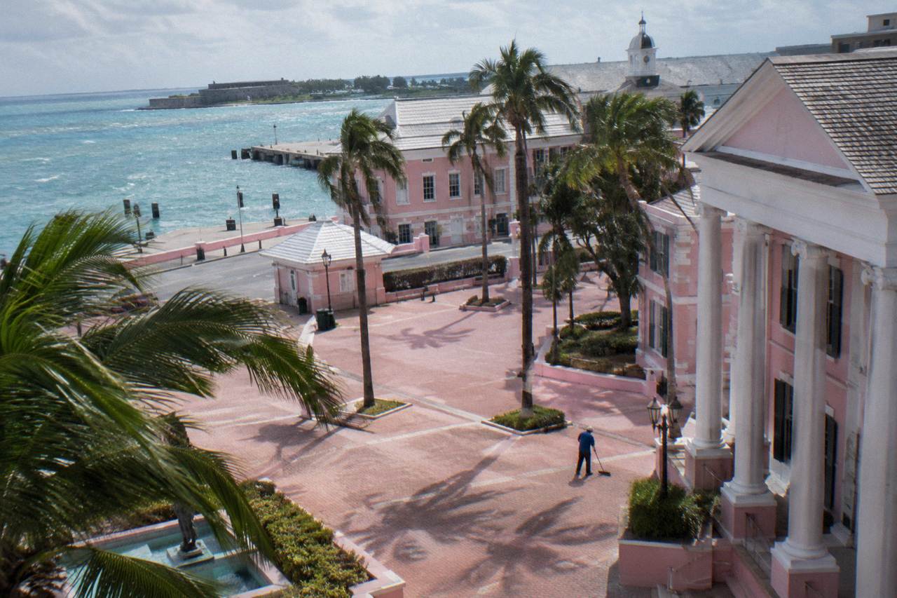 Pastel colonial buildings along a downtown Nassau street with palm trees