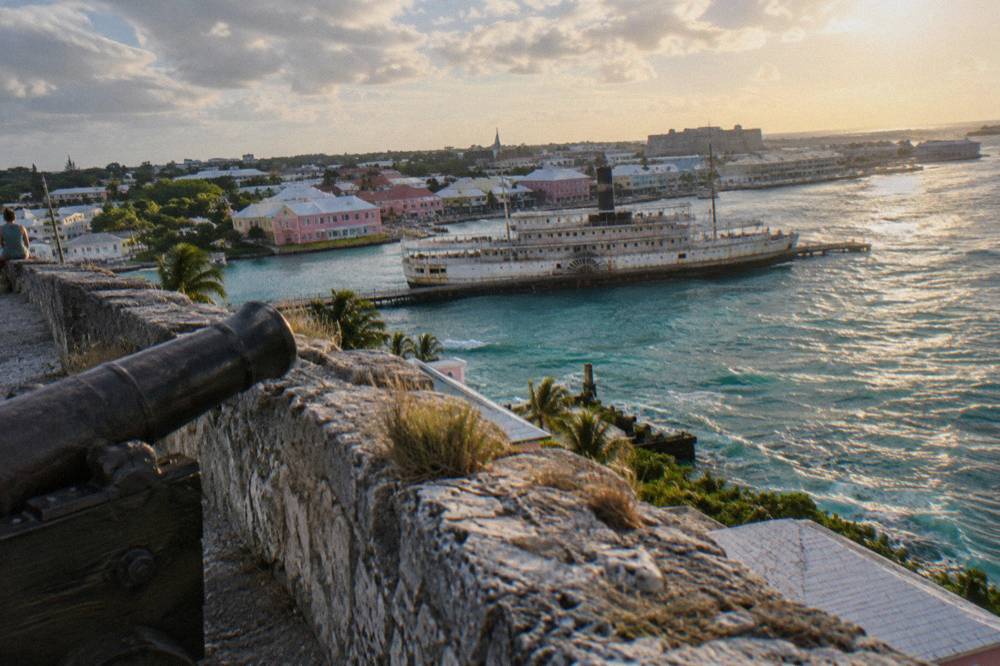 Stone fortification walls overlooking Nassau harbor in late afternoon light