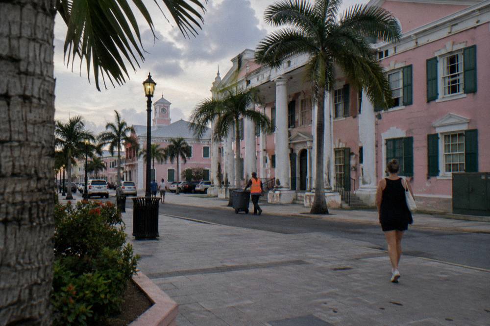 Cobblestone square with colonial government buildings and palm trees in downtown Nassau