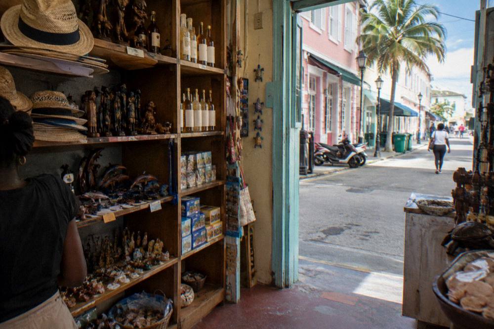 Shopping street in downtown Nassau with pastel storefronts and palm trees