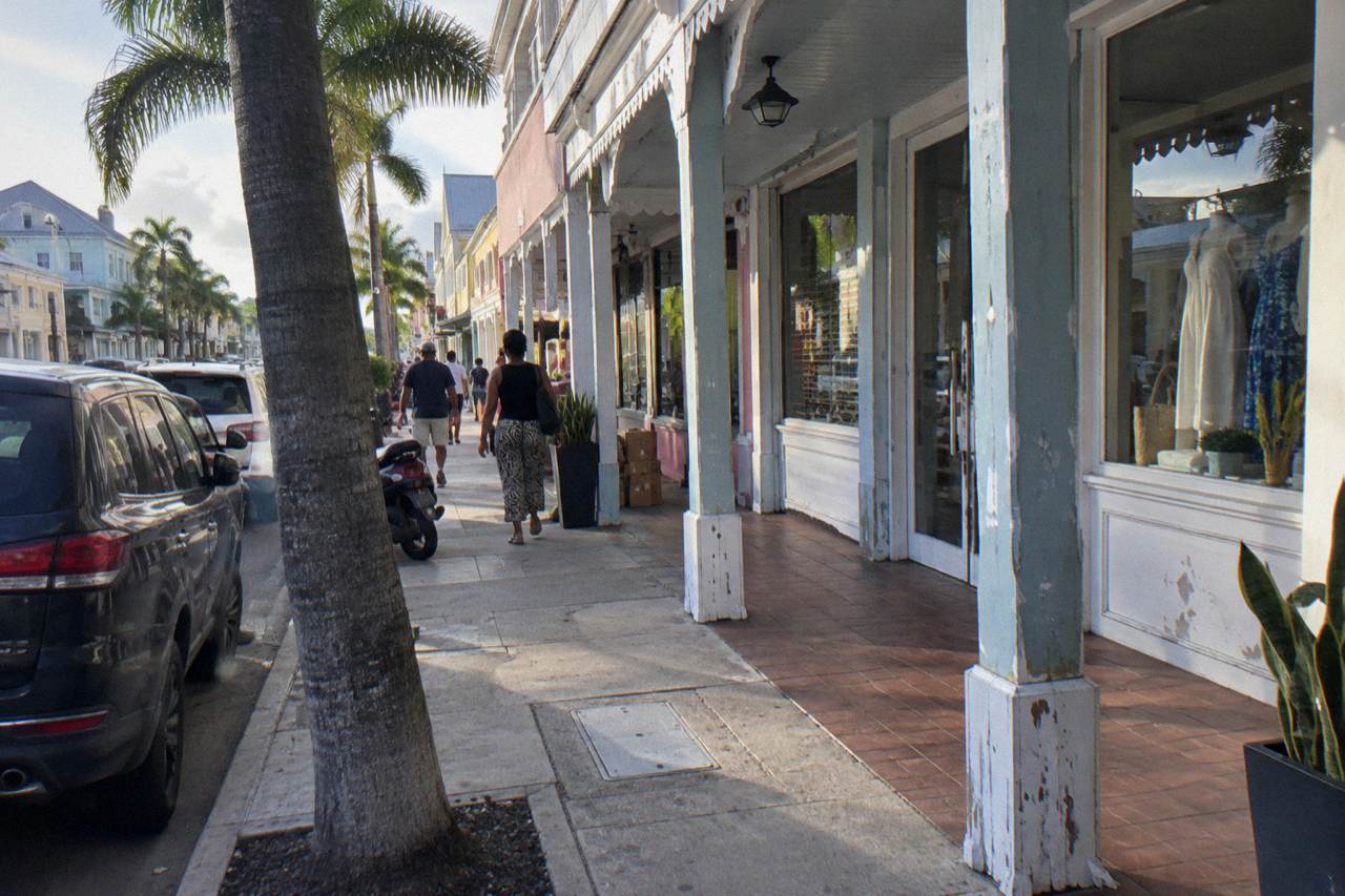 Pastel colonial buildings along a quiet Nassau street with palm trees